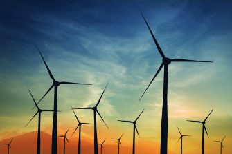 concept idea eco power energy. wind turbine on hill with sunset