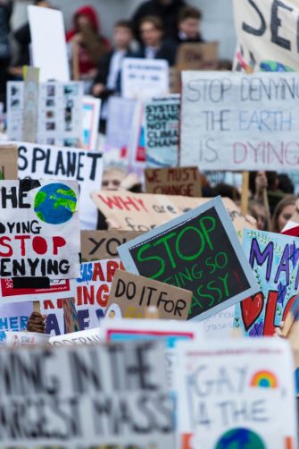 People with banners protest as part of a climate change march