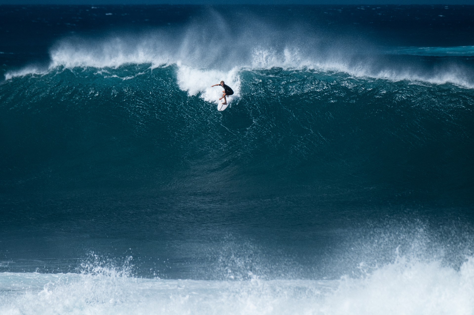 Surfer rides giant wave at the famous Banzai Pipeline surf spot located on the North Shore of Oahu in Hawaii