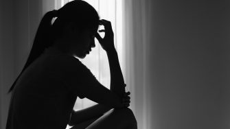 Young  women sitting in dark room feeling pain with life problem.  suffering from husband violence, Stop violence against and sexual abuse women, domestic violence, anti human trafficking.