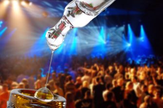 bottle of liquid drug imposed on a background of a rave
