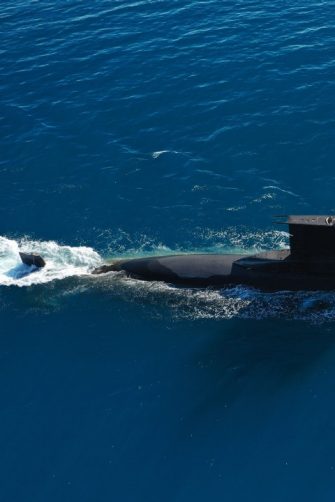 Aerial of a submarine moving through the sea