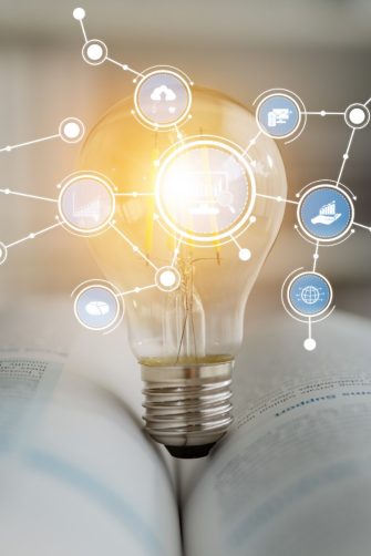 A striking image of a light bulb representing innovation is set on an open book, showcasing the fusion of technology and knowledge with various connected icons. Tessel