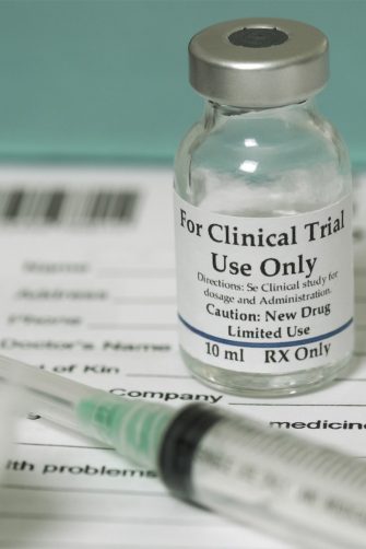 Clinical trial medicine, for the covid-19 coronavirus, on clipboard