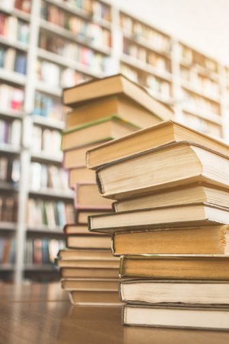 Library books stacked on a desk