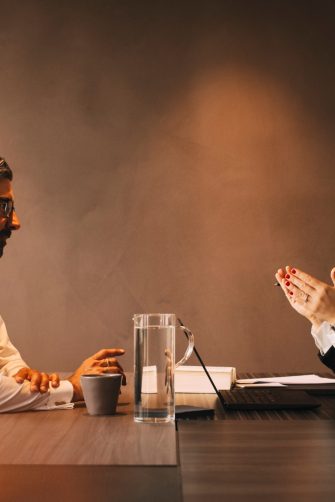 Side view of female lawyer explaining mature client in meeting at office