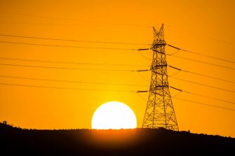Power transmission tower and its power cables installed over a hill in a village near Panvel, Navi Mumbai.