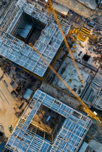 A construction worker pouring a wet concret at road construction site