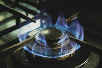 A gas stove element with blue flames