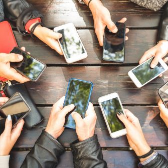 People group having addicted fun together using smartphones - Detail of hands sharing content on social network with mobile smart phones - Technology concept with millennials online with cellphones