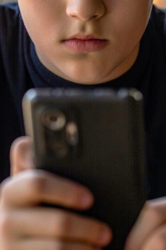 showing social media apps icons of Facebook, Instagram, WhatsApp, Twitter, Youtube, TikTok, Telegram, Gmail, Snapchat - on screen smartphone iPhone with AirPods closeup. Batumi, Georgia - August 9, 2022