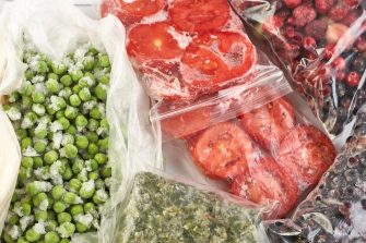 Frozen food in the freezer. Frozen vegetables, soup, ready meals in the freezer