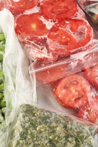 Frozen food in the freezer. Frozen vegetables, soup, ready meals in the freezer
