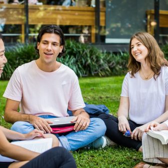Students studying in a group on the grass