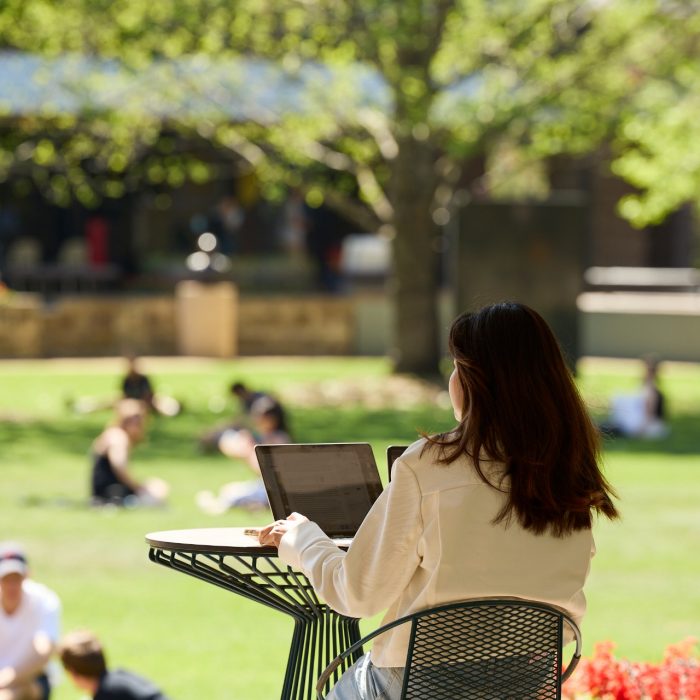 Students relaxing on Library lawn at Kensington UNSW.