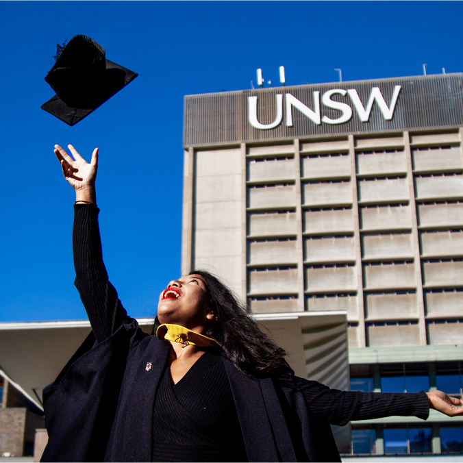 graduate at unsw throwing graduate hat in the air