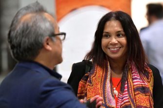lady smiling at man at conference
