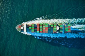 Aerial view of blue and white boat on body of water during daytime photo