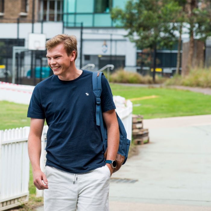 Photo of happy student walking on campus