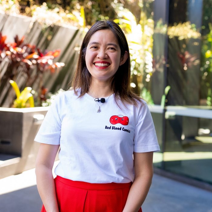 Gita smiling in Outdoor Patio Wearing Red Blood Comic Shirt