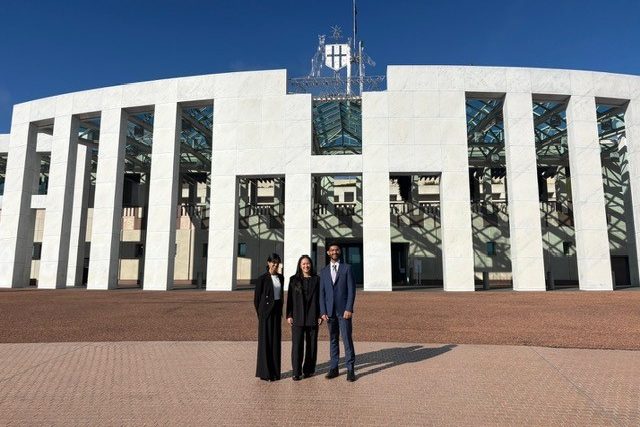UNSW CSI Undergraduate Leadership Fellows standing in front of the Federal Parliament building in Canberra, showcasing the iconic architecture.