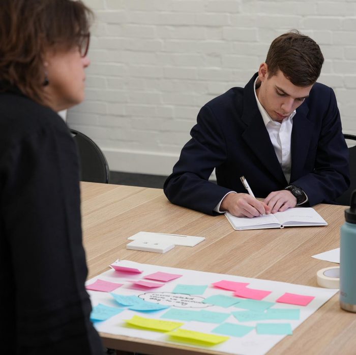 Student working at a table during ADA Innovation Hub Design Sprint 2023