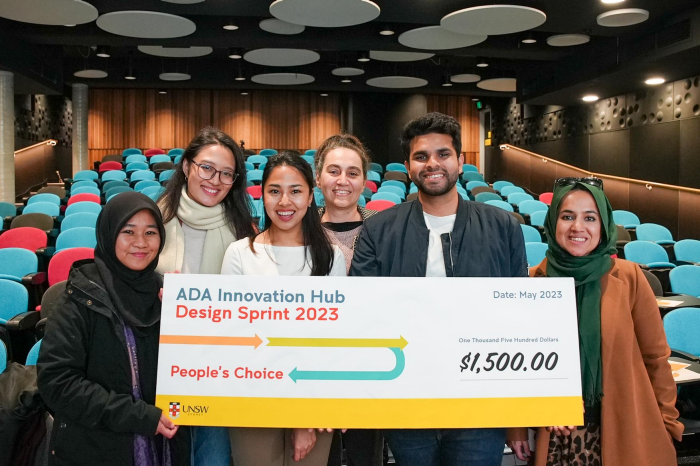 People's choice award winning team from ADA Innovation Hub Design Sprint 2023 hold giant novelty cheque