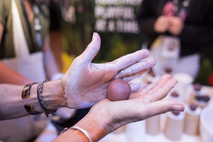 A guest creating a 'seed bomb' with the Daily Delight Disrupt project team