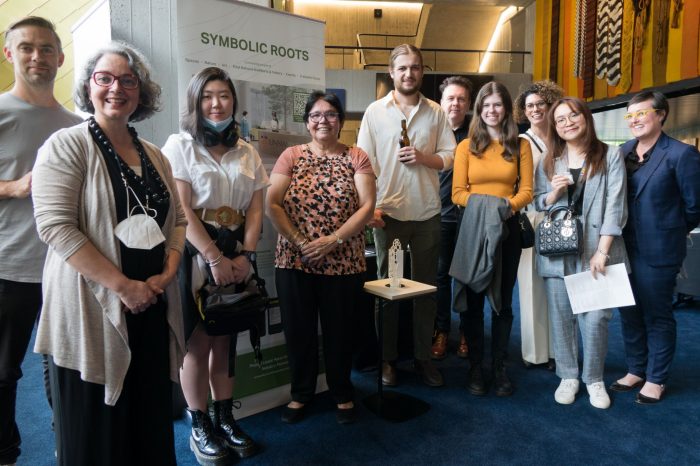 Symbolic Roots team in front of their artefact model presentation