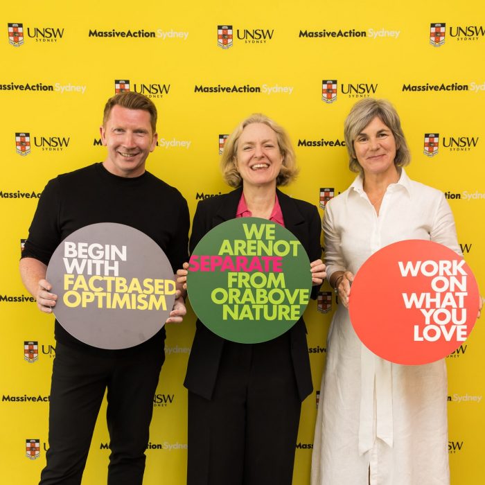 3 people holding colourful buttons with inspirational words written on them