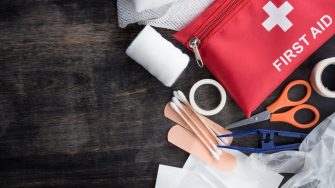 First aid medical kit on wood background,copy space,top view