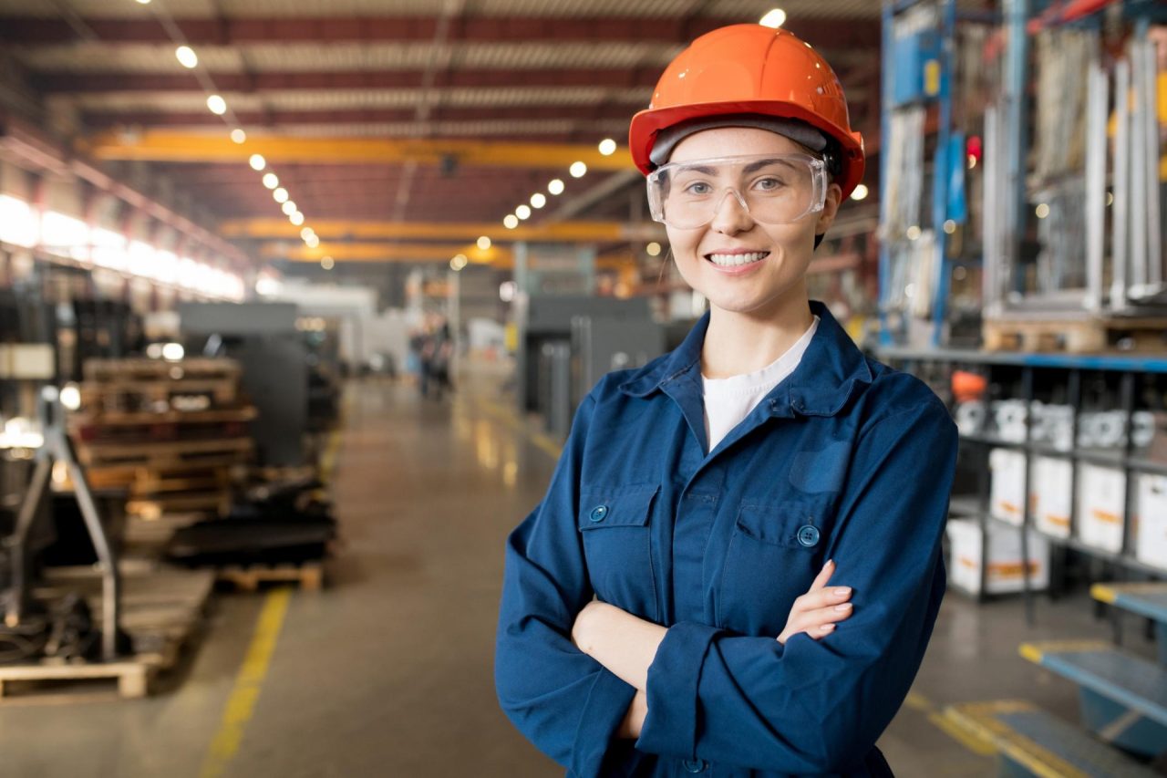 Woman in overalls and hardhat