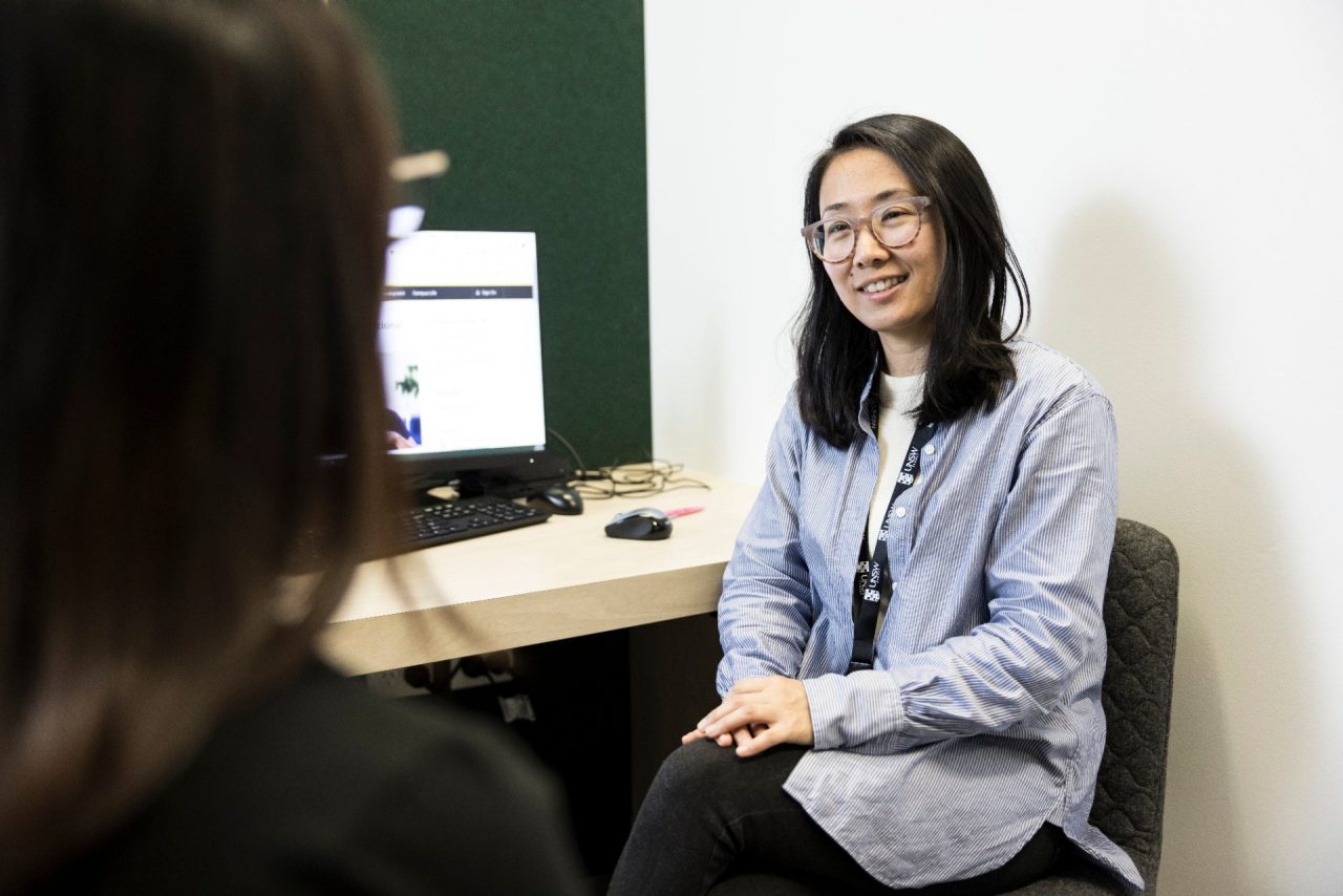 Student Advisor helping student at desk
